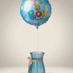 Balloon with "It's a Boy" message for baby shower or gender reveal celebrations.
