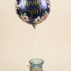 Thank you balloon with floral pattern and gold lettering for special occasions.