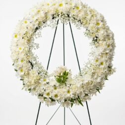 Standing funeral wreath with white chrysanthemums and yellow accents - Forever Floral Gifts.